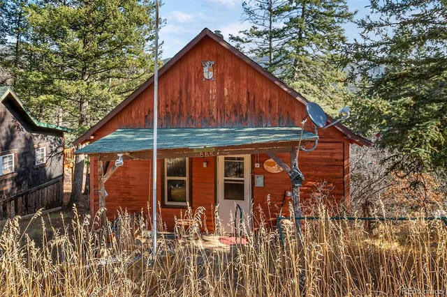 a view of a balcony with wooden floor and outdoor seating