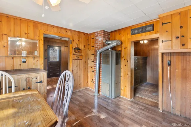 a view of a hallway with furniture and wooden floor