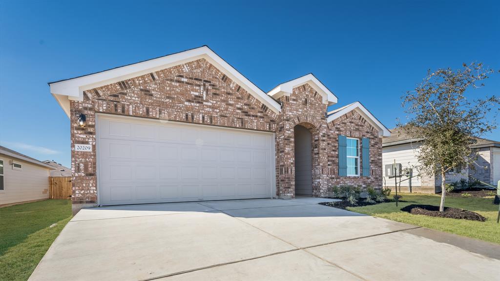 14021 Feinstein Street Manor, TX 78653 - Photo 2 of 25 A classic brick facade welcomes you to this inviting home with a spacious attached garage.