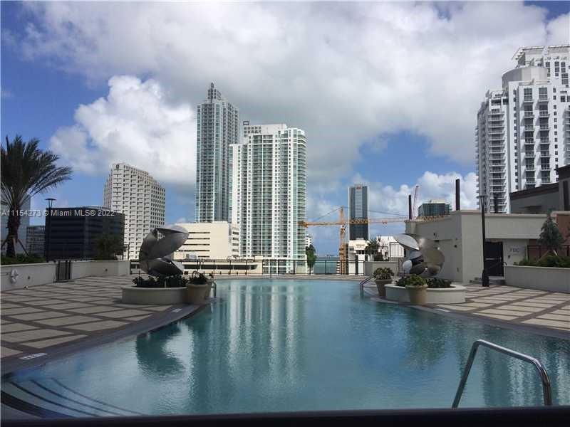 999 Southwest 1st Avenue, Unit 2502 Miami, FL 33130 - Photo 8 of 10 a view of swimming pool with outdoor seating and city view