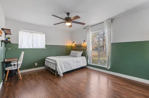 a bedroom with a bed and a window