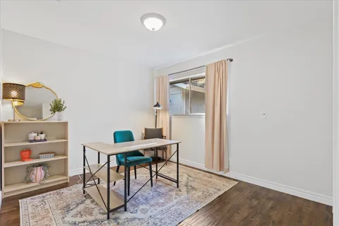 a workspace room with furniture and wooden floor
