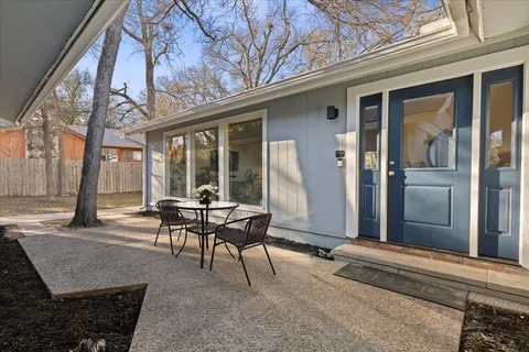 a backyard of a house with outdoor seating