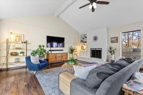 a living room with furniture a potted plant and a fireplace