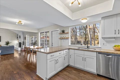 a kitchen with a sink stove and cabinets