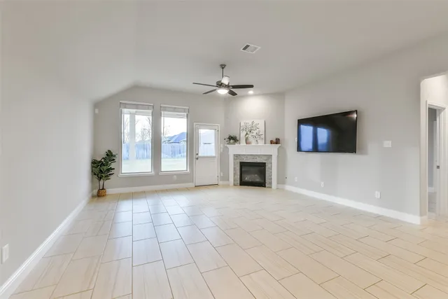 a view of a livingroom with a fireplace and window