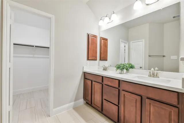 a bathroom with a double vanity sink and a mirror