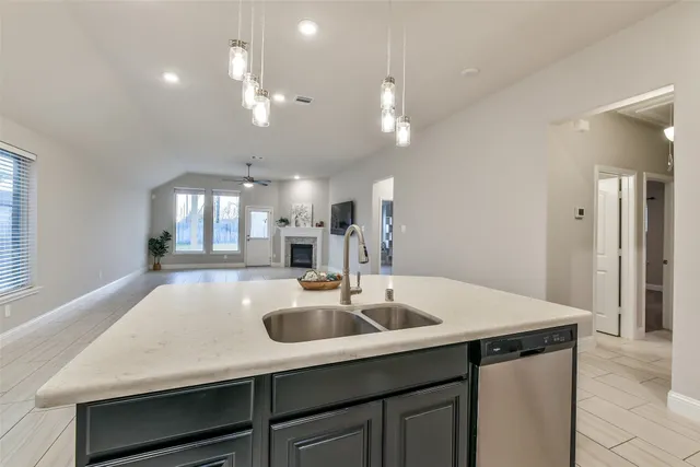 a kitchen with a sink a counter space and stainless steel appliances