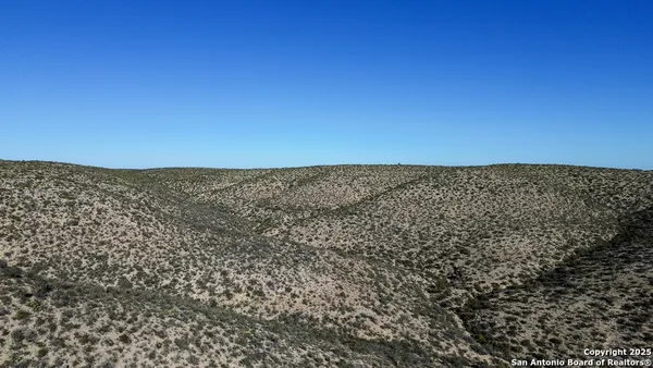 a view of a house with lots of trees