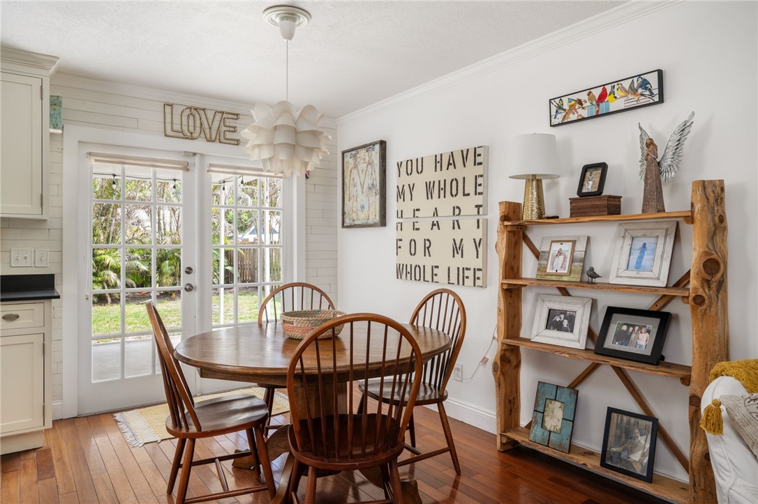 3496 1st Street Southwest Vero Beach, FL 32968 - Photo 11 of 30 a view of a dining room with furniture window and wooden floor