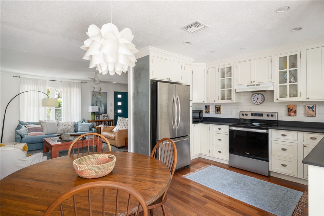 3496 1st Street Southwest Vero Beach, FL 32968 - Photo 12 of 30 a kitchen with stainless steel appliances a dining table and chairs