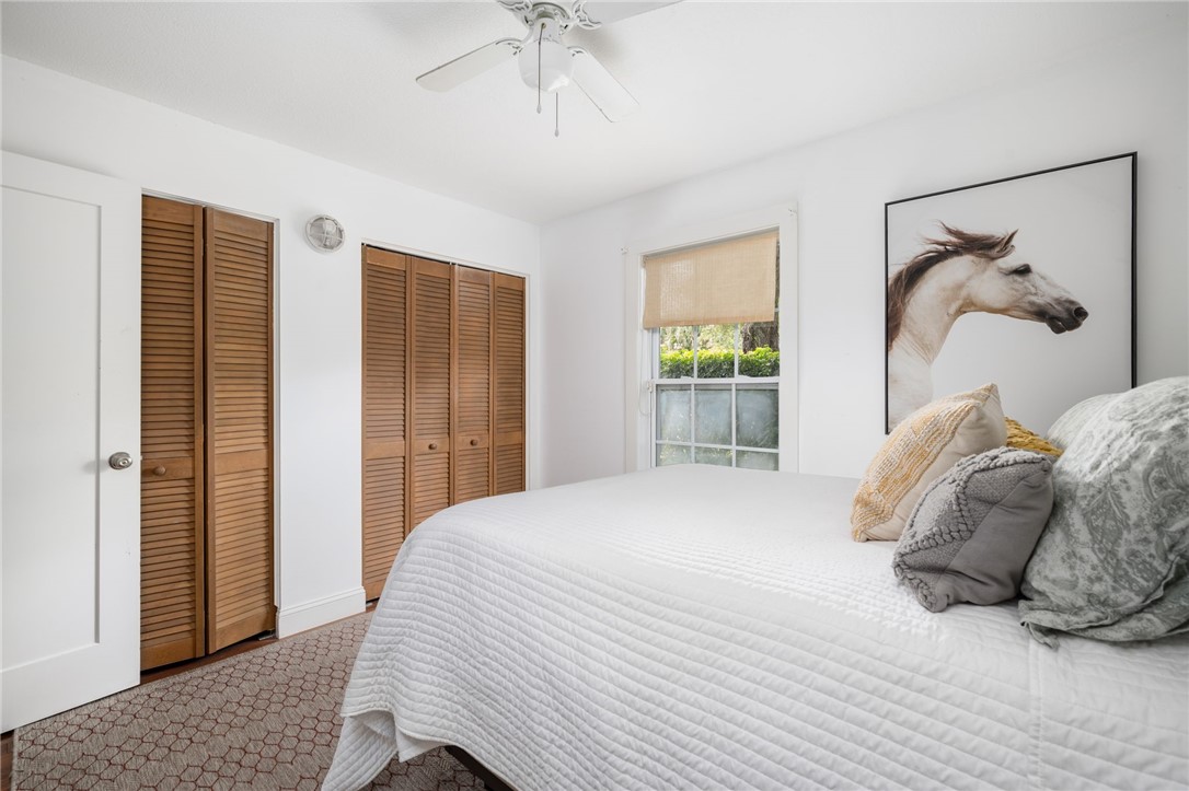 3496 1st Street Southwest Vero Beach, FL 32968 - Photo 15 of 30 a bedroom with a bed and a chandelier