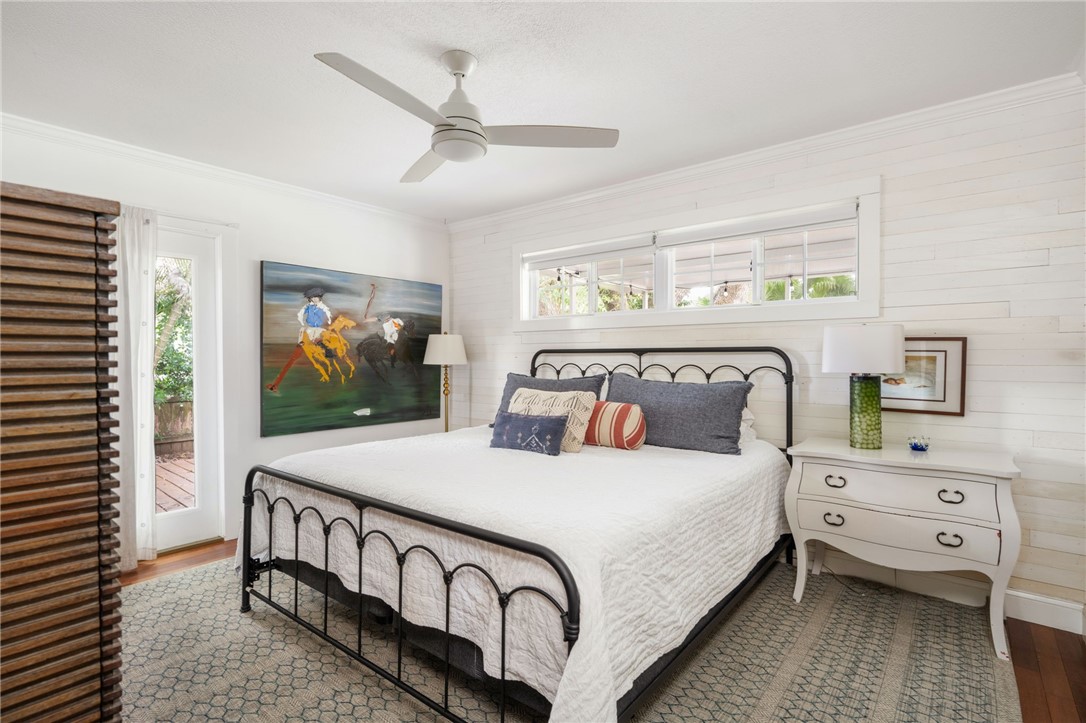 3496 1st Street Southwest Vero Beach, FL 32968 - Photo 18 of 30 a bedroom with a bed and a flat tv screen on dresser