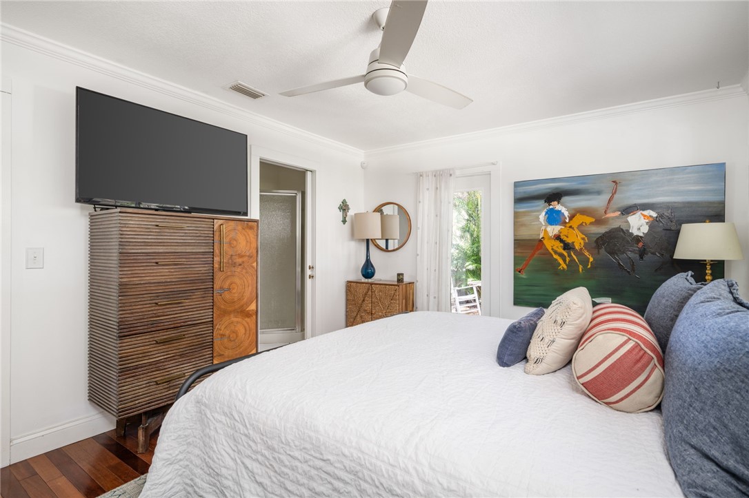 3496 1st Street Southwest Vero Beach, FL 32968 - Photo 20 of 30 a bedroom with a bed and a flat screen tv