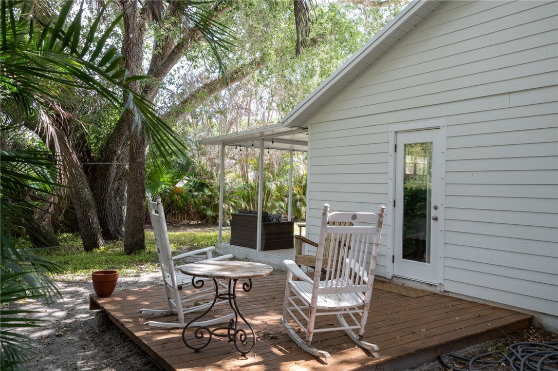3496 1st Street Southwest Vero Beach, FL 32968 - Photo 23 of 30 a view of a patio with table and chairs and potted plants