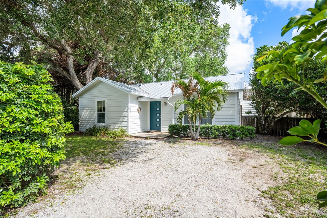 3496 1st Street Southwest Vero Beach, FL 32968 - Photo 26 of 30 a view of a house with a small yard and large tree