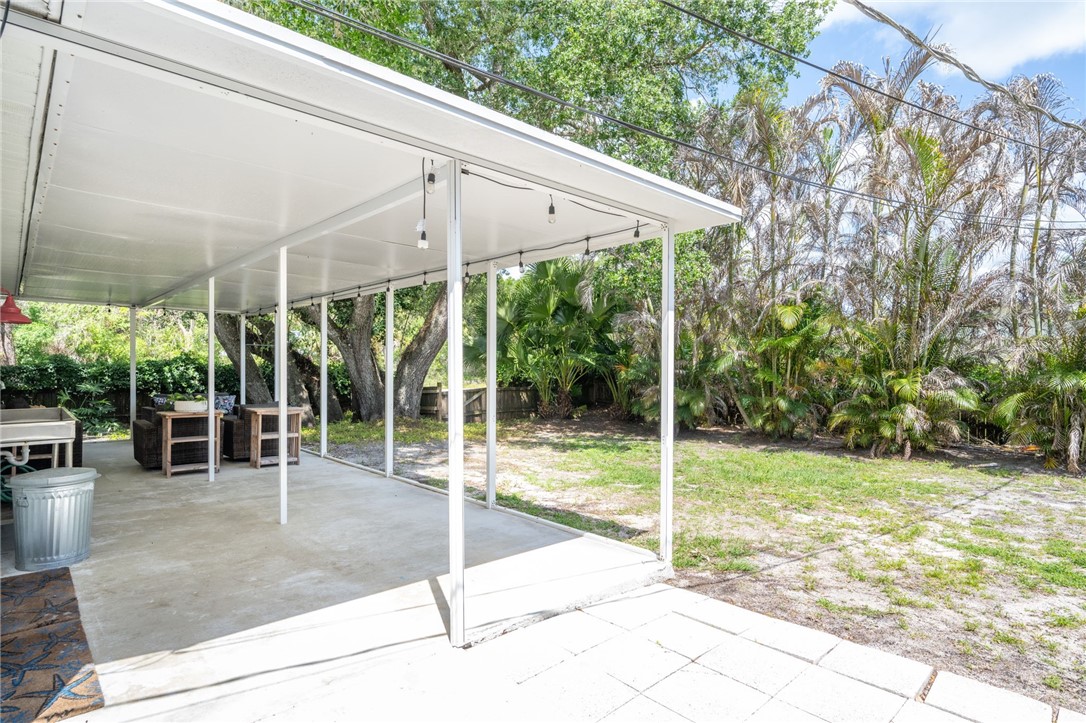 3496 1st Street Southwest Vero Beach, FL 32968 - Photo 28 of 30 a view of a backyard with floor to ceiling windows and wooden fence