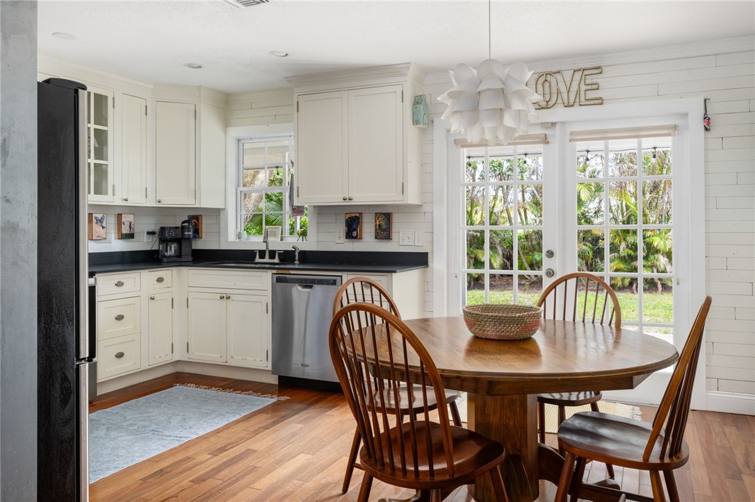 3496 1st Street Southwest Vero Beach, FL 32968 - Photo 8 of 30 a kitchen with a table chairs sink and cabinets