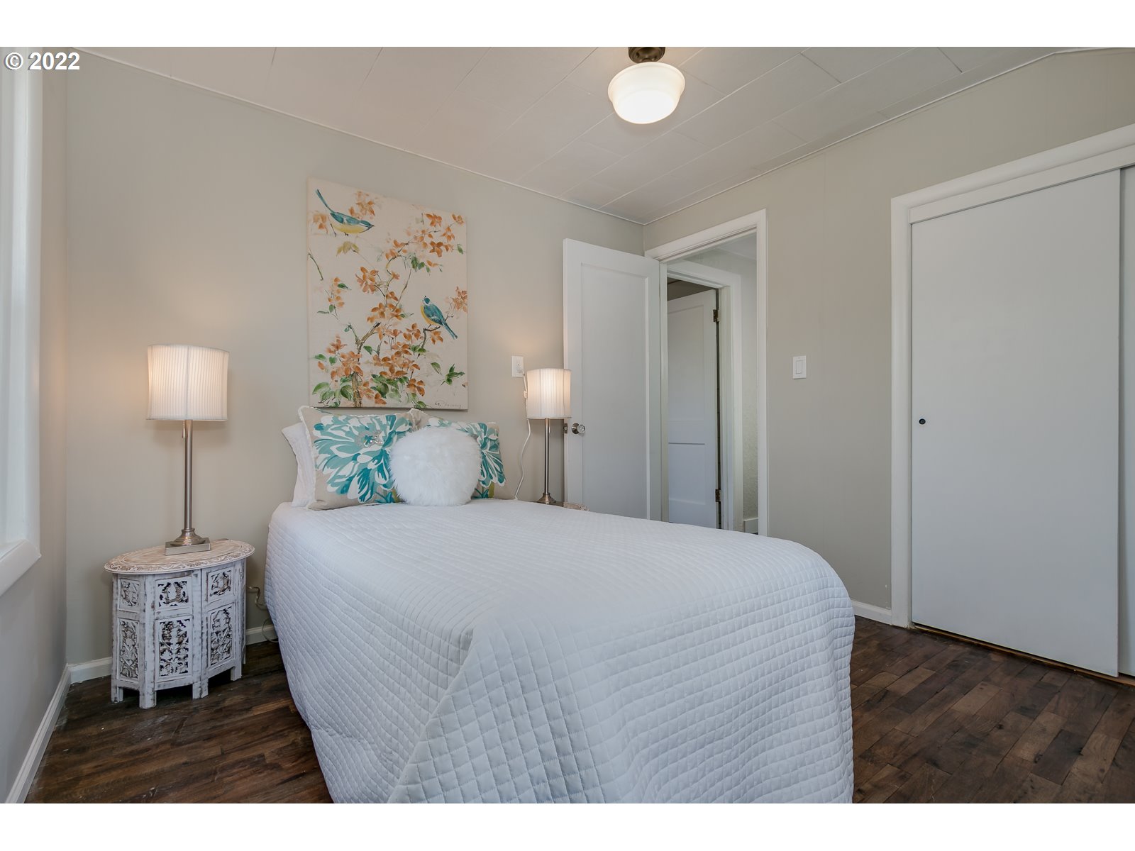 428 18th Street Springfield, OR 97477 - Photo 15 of 22 a bedroom with a bed and a lamp