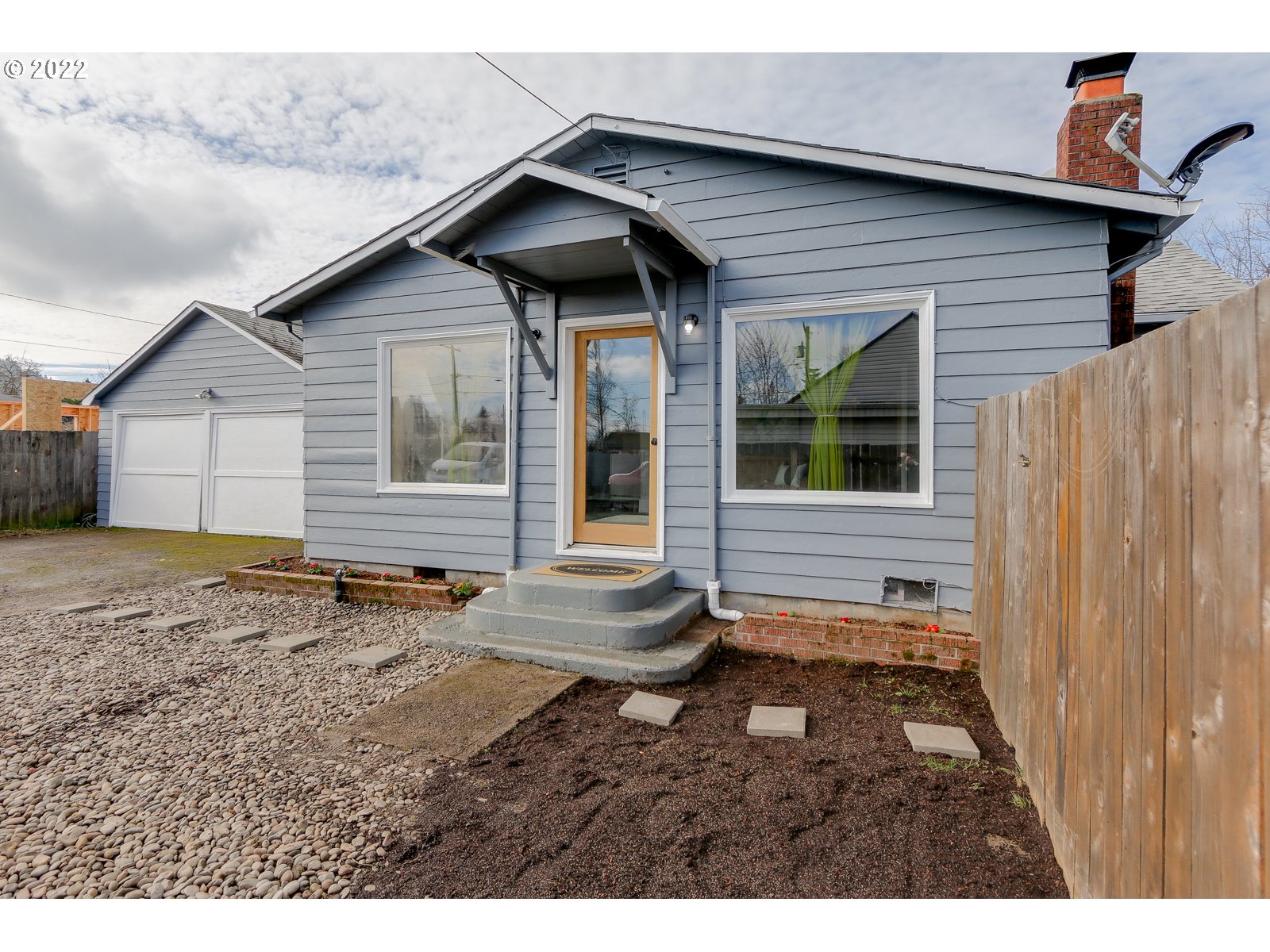 428 18th Street Springfield, OR 97477 - Photo 2 of 22 a backyard of a house with table and chairs