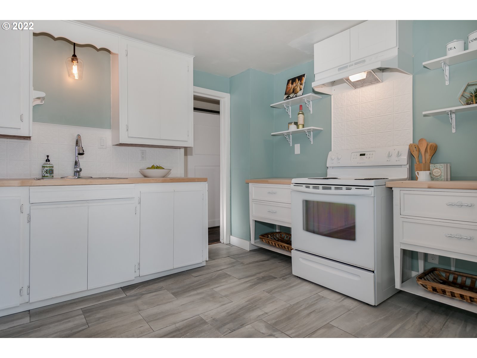 428 18th Street Springfield, OR 97477 - Photo 10 of 22 a kitchen with a stove and white cabinets