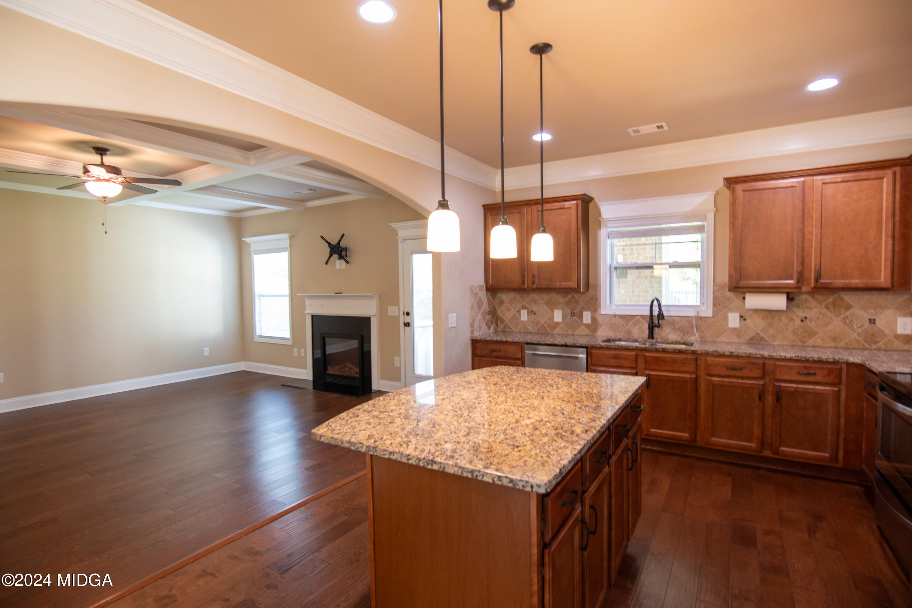 202 Longbridge Way Perry, GA 31069 - Photo 8 of 45 a kitchen with kitchen island granite countertop a stove a sink a center island and wooden floor