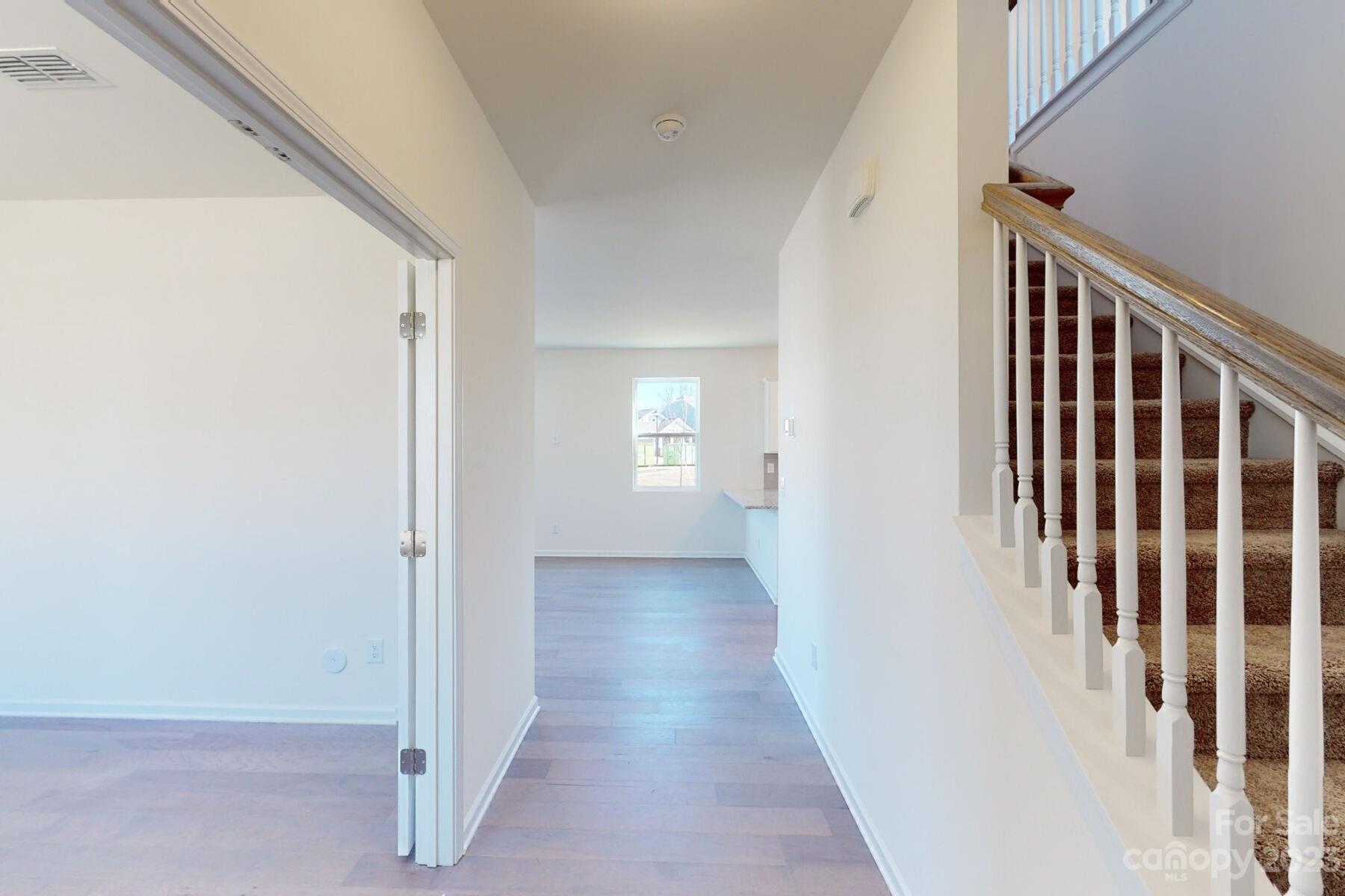 2650 Trinity Street Monroe, NC 28110 - Photo 18 of 36 a view of a hallway with wooden floor and stairs