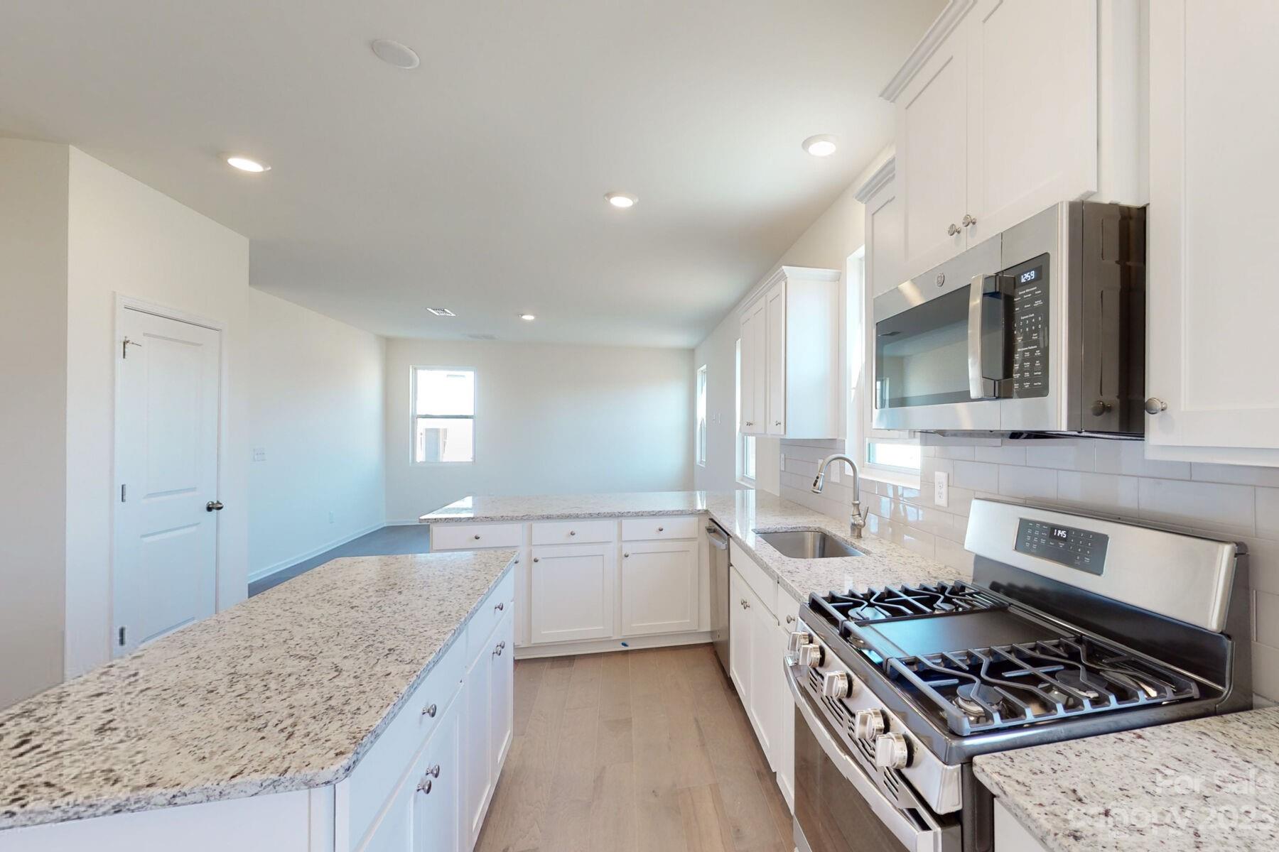 2650 Trinity Street Monroe, NC 28110 - Photo 3 of 36 a kitchen with stainless steel appliances granite countertop a sink stove and cabinets