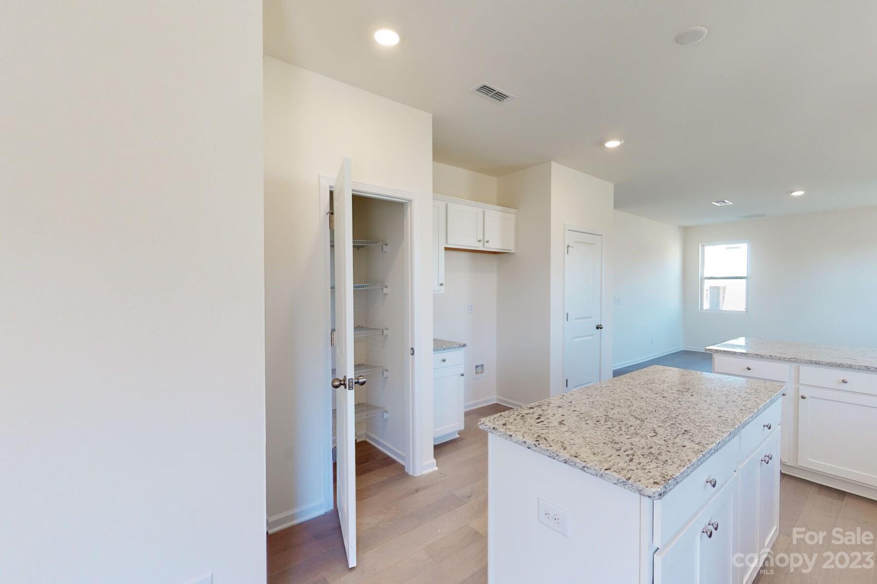 2650 Trinity Street Monroe, NC 28110 - Photo 4 of 36 a bathroom with a granite countertop sink and a mirror