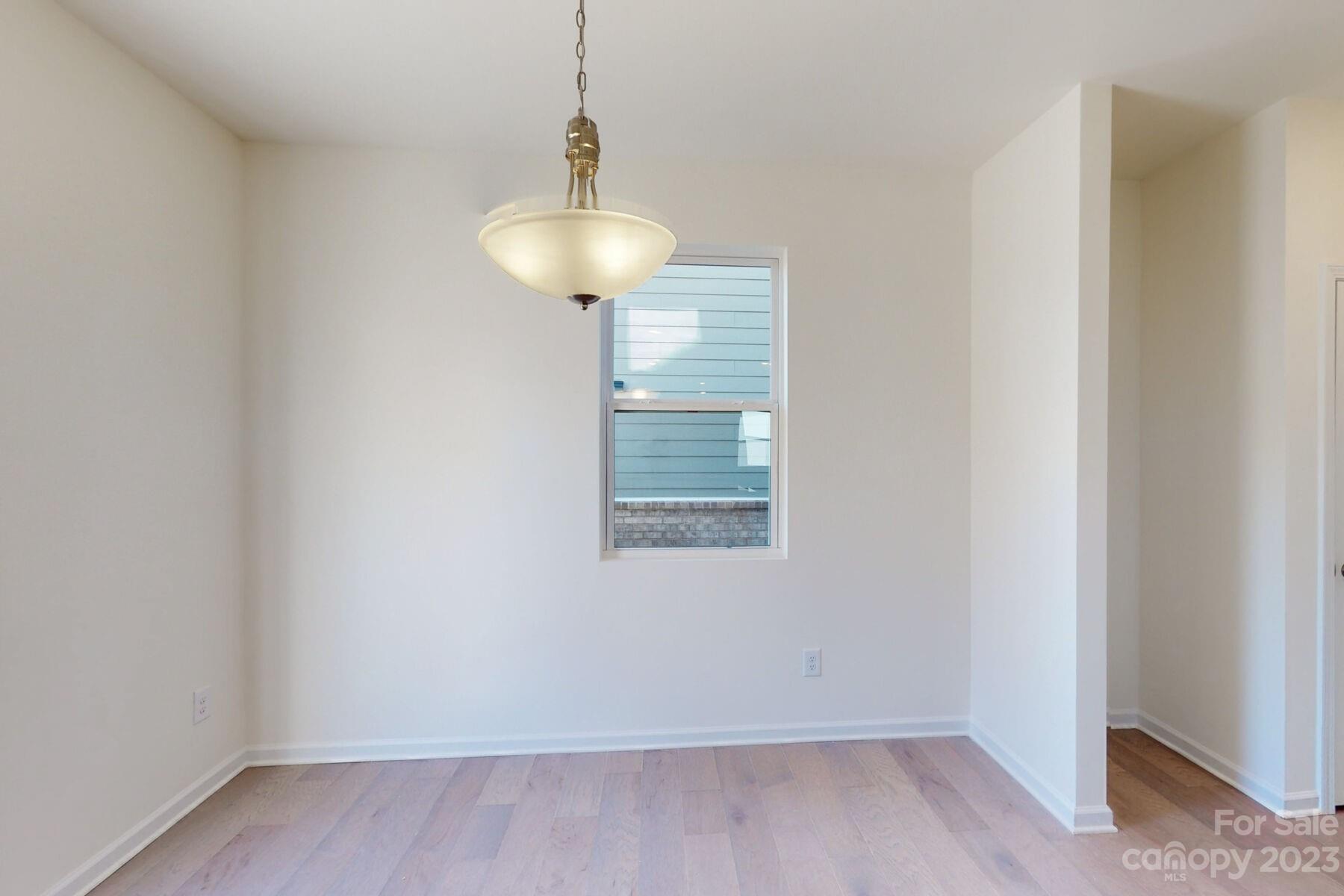 2650 Trinity Street Monroe, NC 28110 - Photo 5 of 36 a view of an empty room with a window and wooden floor