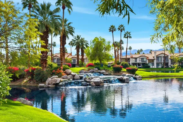 a view of swimming pool with outdoor seating and lake