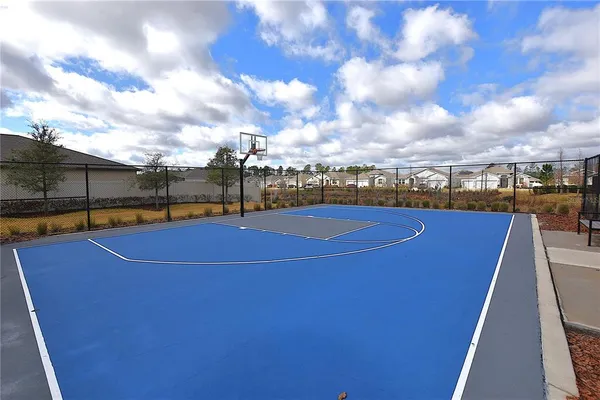 a large kitchen with stainless steel appliances a large center island and a wooden floor