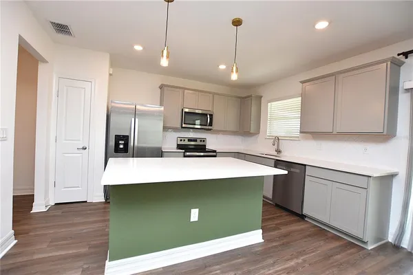 a kitchen with white cabinets and a sink