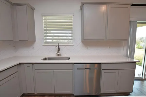 a view of a kitchen with a sink and an oven