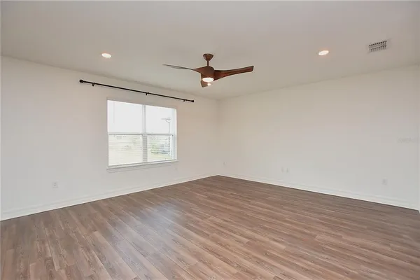a view of an empty room with yard and entryway