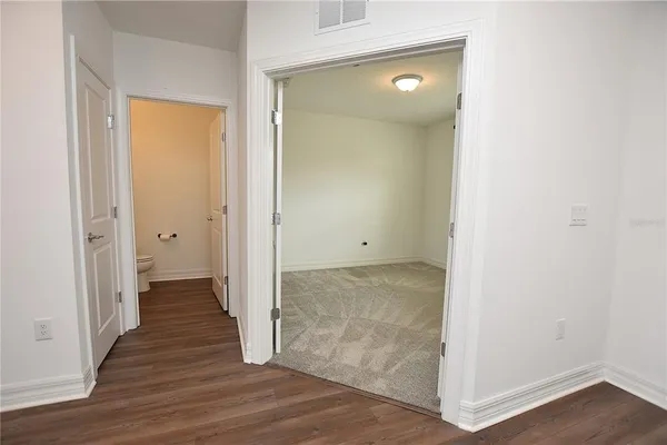 a bathroom with a granite countertop sink a toilet and shower