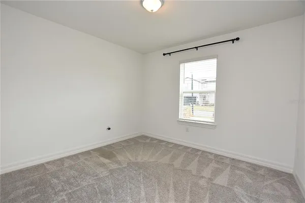 a bathroom with a granite countertop toilet a sink and a mirror