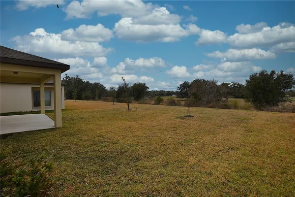 an empty room with a window and a ceiling fan
