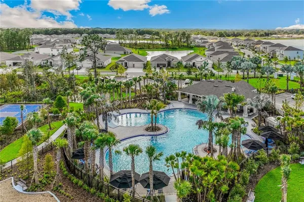 an aerial view of residential house with outdoor space and lake view