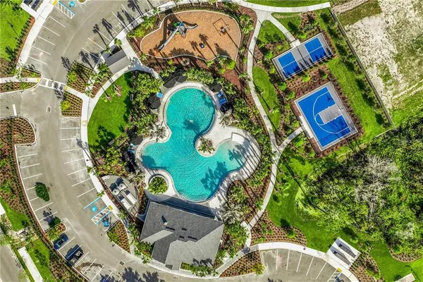 aerial view of a swimming pool with outdoor seating and yard