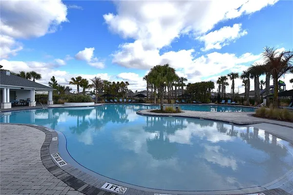 a view of a house with swimming pool and sitting area