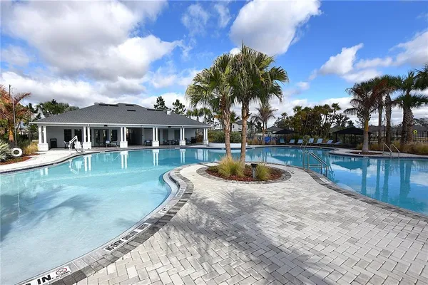 a view of a patio with a table and chairs under an umbrella