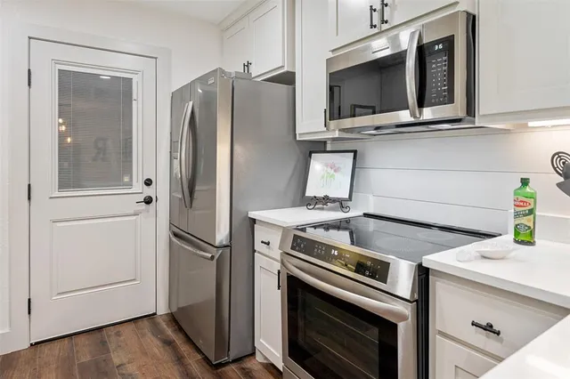 a kitchen with a stove microwave and refrigerator