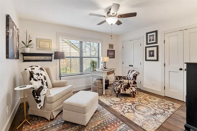 a living room with furniture floor to ceiling window and a rug