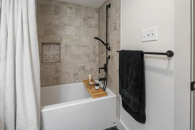 a bathroom with a bathtub and a shower