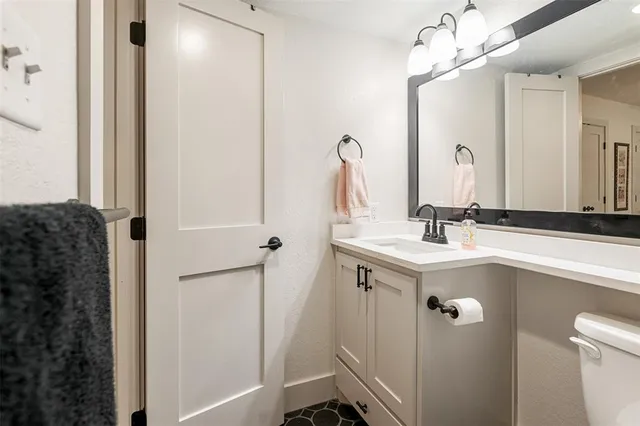 a bathroom with a sink vanity and a mirror