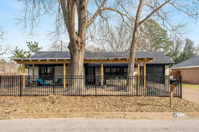 front view of a house with a tree in the background