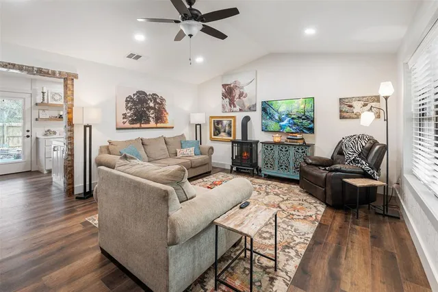 a living room with furniture and a wooden floor