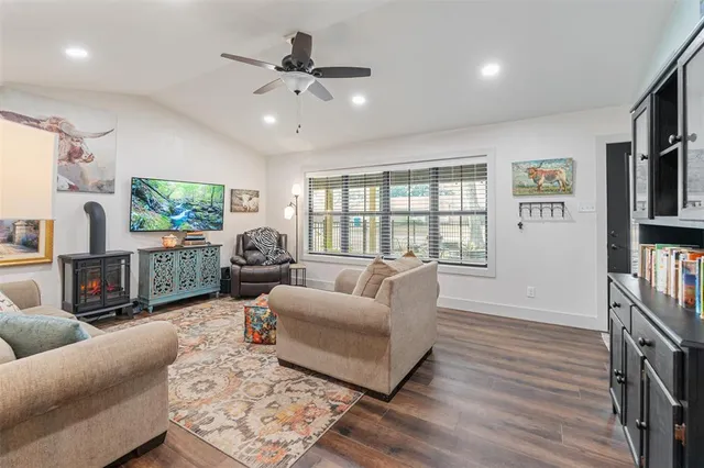 a living room with furniture fireplace and a flat screen tv
