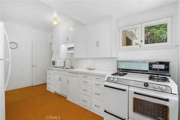 a view of a kitchen with a sink dishwasher and a microwave oven